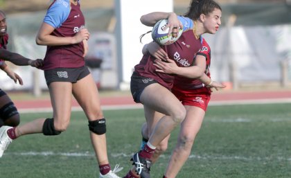 UQ-player-Marioulla-Belessis-is-tackled-as-she-runs-the-ball-forward